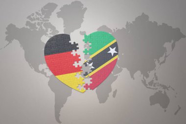 Dünya haritasında Aziz Kitts, Nevis ve Almanya 'nın ulusal bayrağını taşıyan bir bulmaca kalbi. Kavram. 3B illüstrasyon