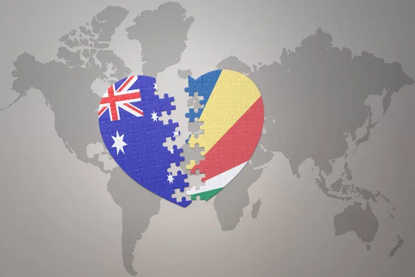 世界地図の背景にセイシェルとオーストラリアの国旗が描かれたパズルハートです コンセプト 3Dイラスト — ストック写真