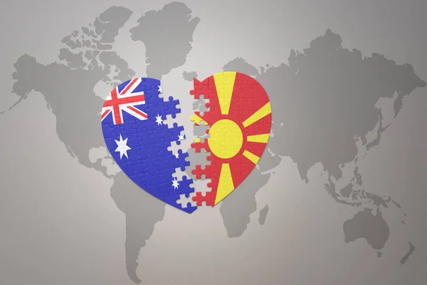 世界地図の背景にマケドニアとオーストラリアの国旗が描かれたパズルハートです コンセプト 3Dイラスト — ストック写真