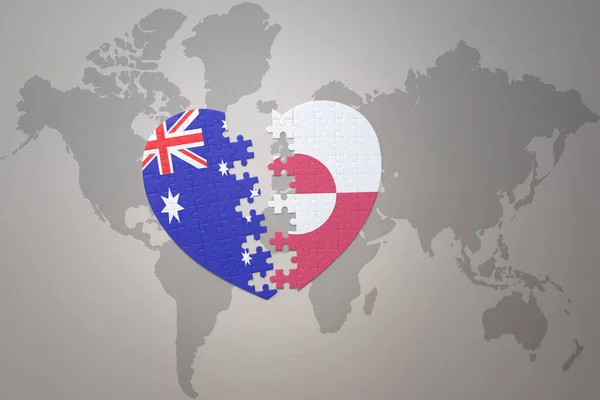 パズルハートで世界地図の背景にグリーンランドとオーストラリアの国旗が描かれています コンセプト 3Dイラスト — ストック写真