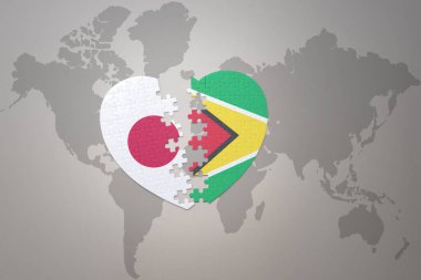 Japonya ve Guyana 'nın ulusal bayrağını taşıyan yapboz kalp dünya haritası arka planında. Kavram. 3B illüstrasyon