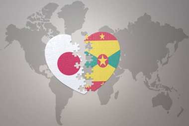 Japonya ve Grenada 'nın ulusal bayrağını taşıyan yapboz kalp dünya haritası arka planında. Kavram. 3B illüstrasyon