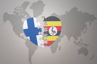 Dünya haritasının arka planında Uganda ve Finlandiya 'nın ulusal bayrağı olan bir bulmaca kalbi. Kavram. 3B illüstrasyon