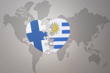Dünya haritasının arka planında Uruguay ve Finlandiya 'nın ulusal bayrağı olan bir bulmaca kalbi. Kavram. 3B illüstrasyon