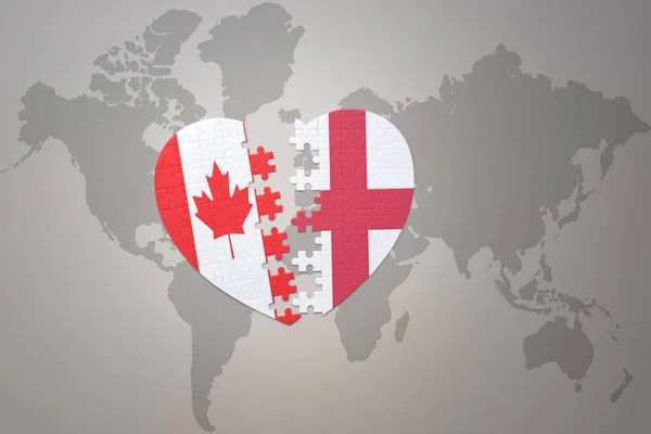 Puzzleherz Mit Der Nationalflagge Kanadas Und Englands Auf Einem Weltkartenhintergrund — Stockfoto
