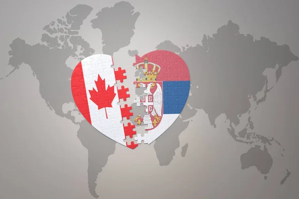 Puzzleherz Mit Der Nationalflagge Kanadas Und Serbiens Auf Einer Weltkarte — Stockfoto