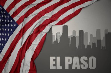 Gri bir arka planda Amerika Birleşik Devletleri 'nin renkli bayrağını sallayan el Paso yazısıyla şehrin soyut silueti.