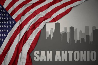 Amerika Birleşik Devletleri 'nin gri arka planında renkli bayrağını sallayan San Antonio yazısıyla şehrin soyut silueti.