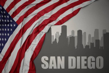 Amerika Birleşik Devletleri 'nin gri arka planında renkli bayrağını sallayan San Diego yazısıyla şehrin soyut silueti.