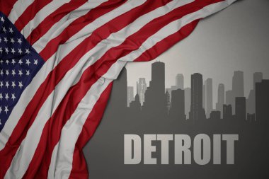 Amerika Birleşik Devletleri 'nin gri arka planında renkli bayrağını sallayan metin Detroit' li soyut silueti.