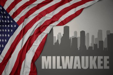 Amerika Birleşik Devletleri 'nin gri arka planında renkli bayrağını sallayan Milwaukee yazısıyla şehrin soyut silüeti.
