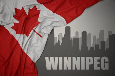 Şehrin soyut silueti. Winnipeg, gri arka planda renkli Kanada bayrağı dalgalandırıyor..