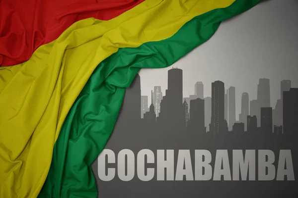 科恰班巴 Cochabamba 在灰色背景下挥舞着五颜六色的玻利维亚国旗 — 图库照片