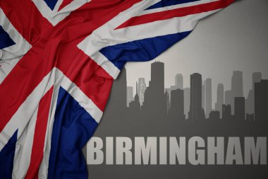 Kentin soyut silueti Birmingham 'ın gri bir arkaplanda büyük Britanya bayrağının dalgalandığı renkli bir yazı ile.