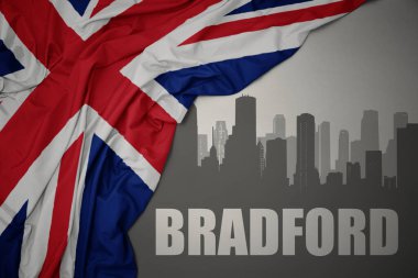 Şehrin soyut silueti. Üzerinde Bradford yazıları var. Gri bir arkaplanda büyük Britanya bayrağı sallanıyor..