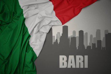 Şehrin soyut silueti. Bari, gri bir arkaplanda renkli ulusal bayrak sallıyor..