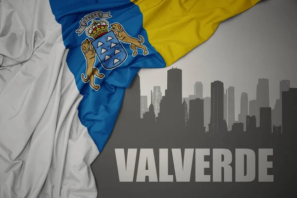 Abstrakcyjna Sylwetka Miasta Tekstem Valverde Pobliżu Machania Kolorowe Flagi Narodowej — Zdjęcie stockowe