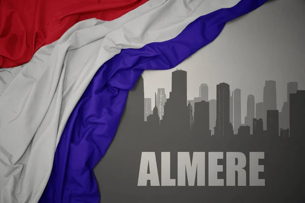 Abstrakcyjna Sylwetka Miasta Tekstem Almere Nieopodal Machania Barwną Flagą Narodową — Zdjęcie stockowe