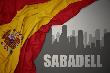 Şehrin soyut silueti. Sabadell, gri bir arkaplanda renkli İspanya bayrağı sallıyor..