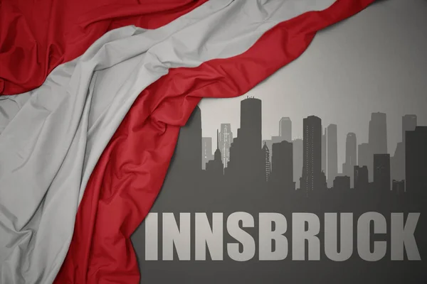 Abstrakte Silhouette Der Stadt Mit Schriftzug Innsbruck Bei Schwenkender Nationalflagge — Stockfoto