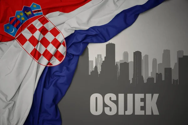 Silueta Abstracta Ciudad Con Texto Osijek Cerca Ondeando Colorida Bandera —  Fotos de Stock