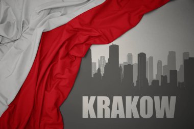 Şehrin soyut silueti. Krakow, gri bir arkaplanda renkli bir Polonya bayrağı dalgalandırıyor..