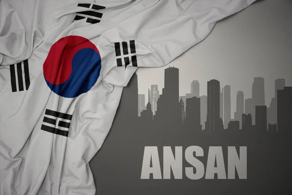 灰色の背景に韓国のカラフルな国旗を振って近くにテキストAnsanと都市の抽象的なシルエット — ストック写真