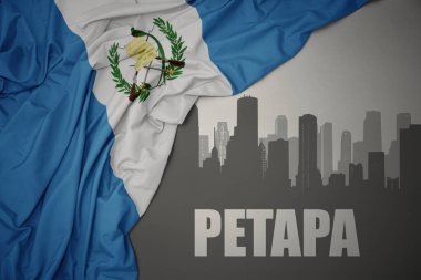 Gri arka planda renkli Guatemala bayrağı sallayan Petapa yazısıyla şehrin soyut silueti. 3B illüstrasyon
