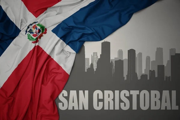 Abstrakcyjna Sylwetka Miasta Tekstem San Cristobal Pobliżu Machania Barwną Flagą — Zdjęcie stockowe