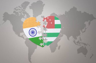 puzzle heart with the national flag of india and abkhazia on a world map background.Concept. 3D illustration