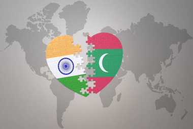 puzzle heart with the national flag of india and maldives on a world map background.Concept. 3D illustration
