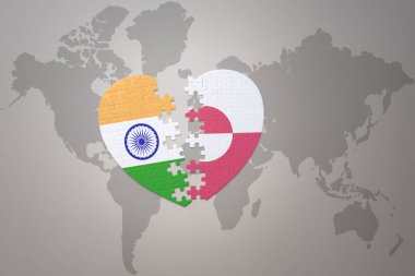 puzzle heart with the national flag of india and greenland on a world map background.Concept. 3D illustration