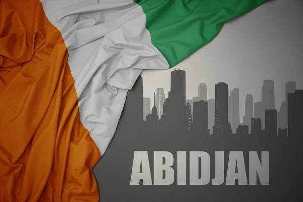 Abstract Silhouette City Text Abidjan Waving Colorful National Flag Cote — 스톡 사진