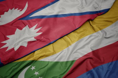 waving colorful flag of comoros and national flag of nepal. macro.3d illustration