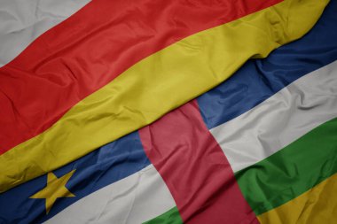 waving colorful flag of central african republic and national flag of south ossetia. macro.3d illustration
