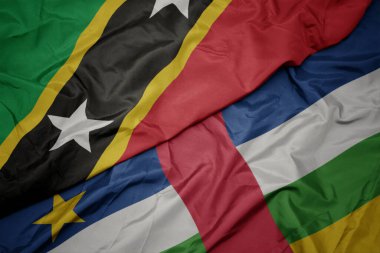 waving colorful flag of central african republic and national flag of saint kitts and nevis. macro.3d illustration