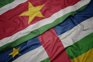waving colorful flag of central african republic and national flag of suriname. macro.3d illustration