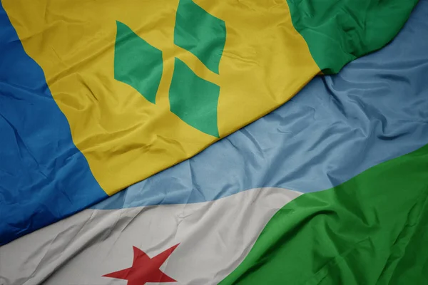 waving colorful flag of djibouti and national flag of saint vincent and the grenadines. macro.3d illustration