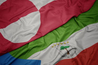 waving colorful flag of equatorial guinea and national flag of greenland. macro.3d illustration