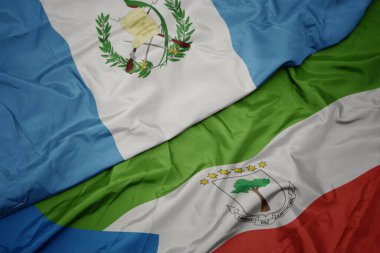waving colorful flag of equatorial guinea and national flag of guatemala. macro.3d illustration