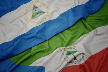 waving colorful flag of equatorial guinea and national flag of nicaragua. macro.3d illustration
