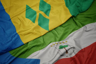 waving colorful flag of equatorial guinea and national flag of saint vincent and the grenadines. macro.3d illustration