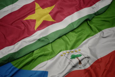 waving colorful flag of equatorial guinea and national flag of suriname. macro.3d illustration