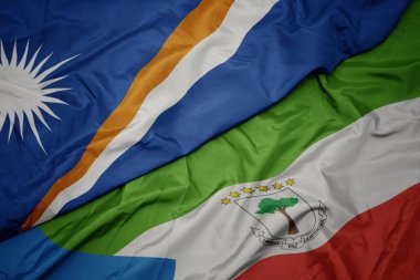 waving colorful flag of equatorial guinea and national flag of Marshall Islands . macro.3d illustration