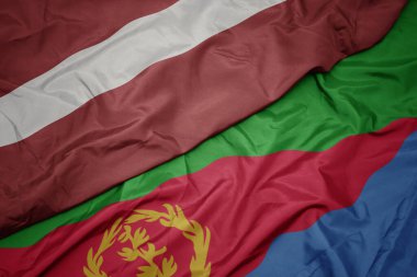 waving colorful flag of eritrea and national flag of latvia. macro.3d illustration