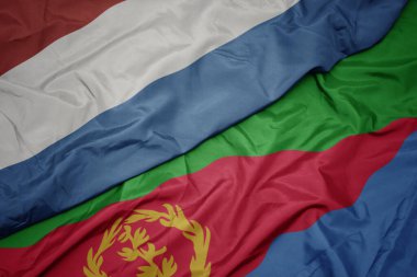 waving colorful flag of eritrea and national flag of luxembourg. macro.3d illustration