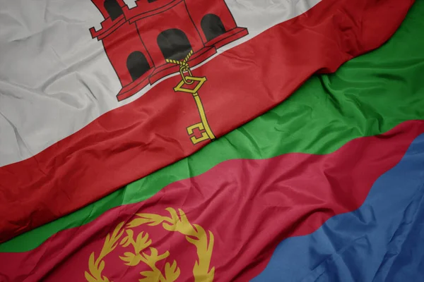 waving colorful flag of eritrea and national flag of gibraltar. macro.3d illustration