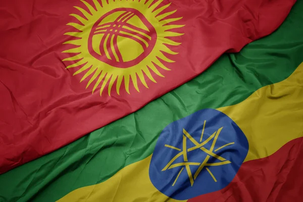 waving colorful flag of ethiopia and national flag of kyrgyzstan. macro.3d illustration