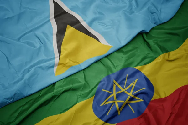 waving colorful flag of ethiopia and national flag of saint lucia. macro.3d illustration