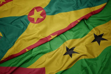 waving colorful flag of sao tome and principe and national flag of grenada. macro.3d illustration